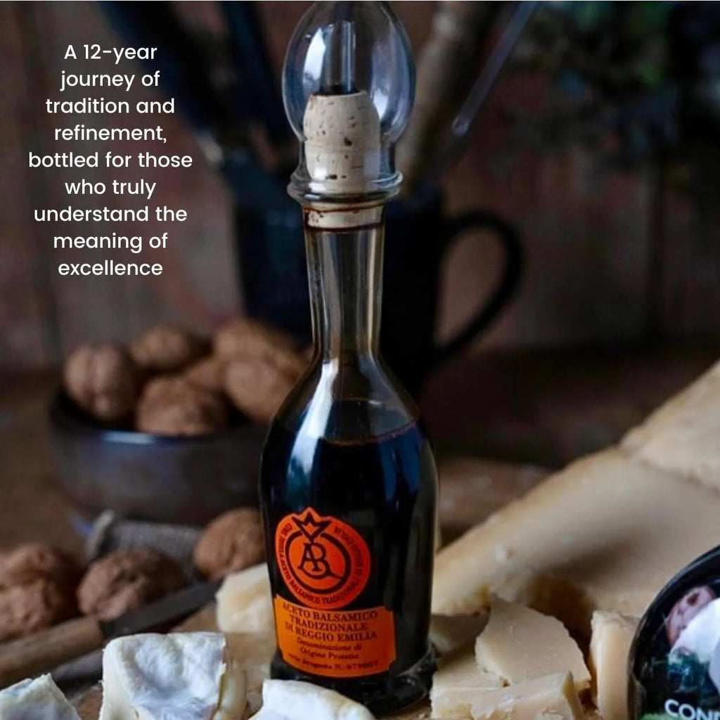 Bottle of D.O.P. Reggio Emilia balsamic vinegar with cheese and nuts on a wooden surface