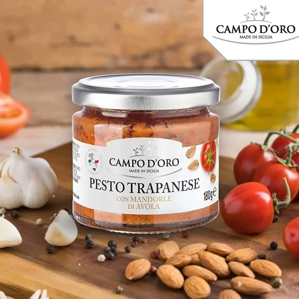 Jar of Campo d'Oro Pesto Trapanese with ingredients on a wooden board